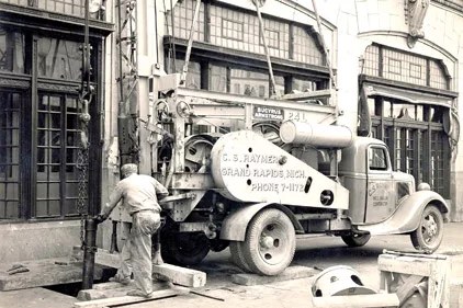 A driller with C.S. Raymer of Grand Rapids, Mich., works with the help of an old Bucyrus cable rig.