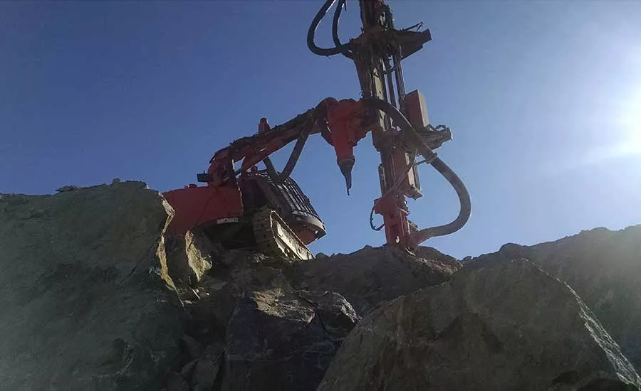 drilling rig on rock outcropping