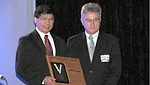 Chunmiao Zheng, left, accepts the group's top science award from NGWA President Daniel T. Meyer.