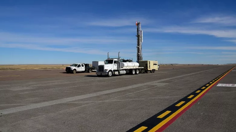 A contract drilling crew installs a monitoring well on the ramp of the 120th Airlift Wing in Great Falls, Montana