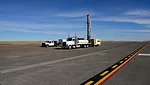 A contract drilling crew installs a monitoring well on the ramp of the 120th Airlift Wing in Great Falls, Montana