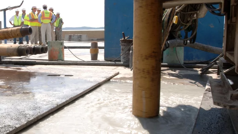 drilling crew operates on a work platform at Wolf Creek Dam in Jamestown, Kentucky