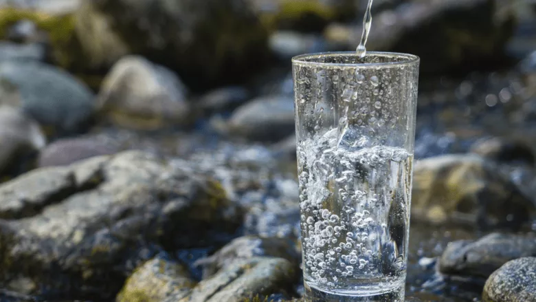 An image of a cup being filled up with water.