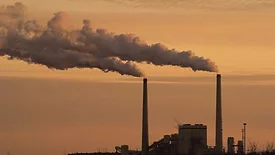 A coal plant blowing smoke near Lake Michigan