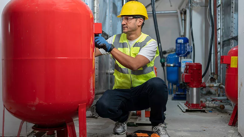 worker installing water storage system