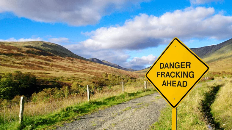 An image of a fracking sign in the countryside