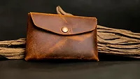 An image of a dark leather coin purse