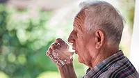 drinking water image A senior drinking water from a cup