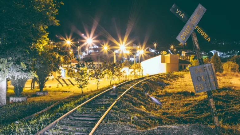 An image of a railroad at night