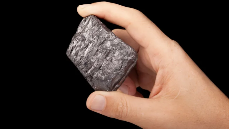 An image of someone holding graphite on a black background