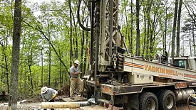 An image of a Drill rig in the forest