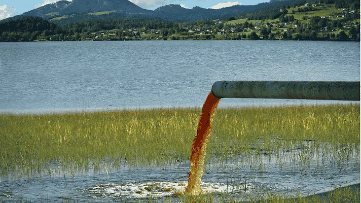 An image of hazardous waste flowing into a lake