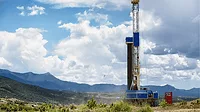 AN image of a fracking drill rig in the mountains