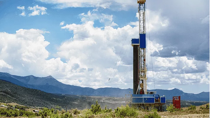 AN image of a fracking drill rig in the mountains