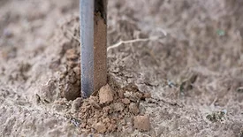 An image of someone testing soil