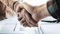 An image of two business people shaking hands