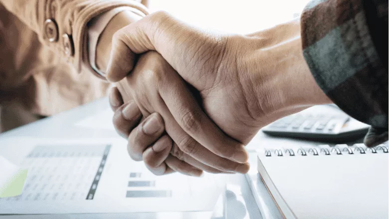 An image of two business people shaking hands