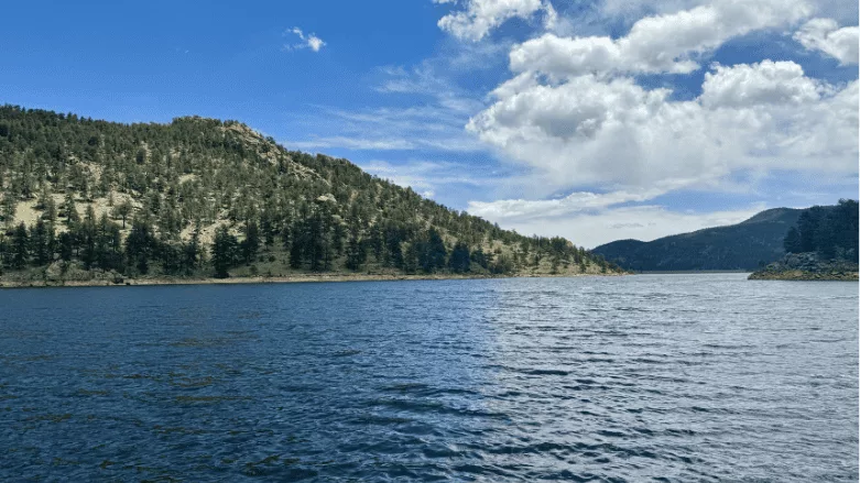 An image of a reservoir in Colorado with mountains in the background