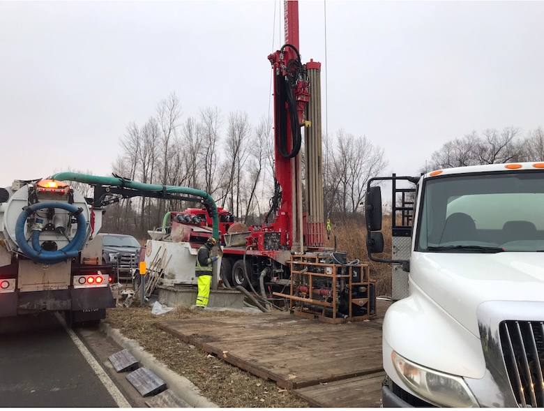 Drillers next to a drill rig