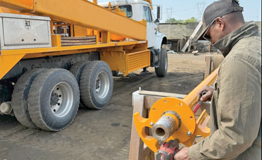 2 men on site with a piece of machinery