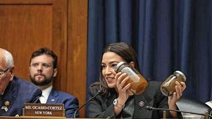 New York Senator Alexandria Ocasio-Cortez holding-Jars-of-Dirty-Well-Water from Georiga