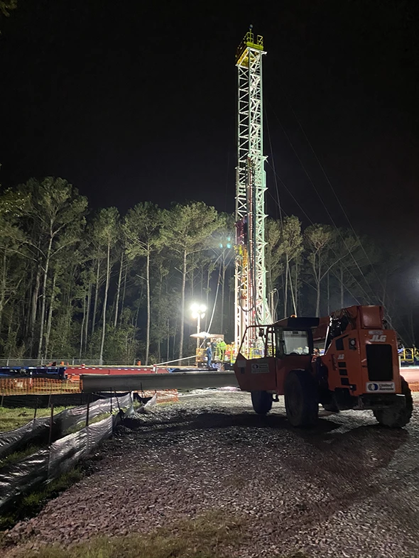 A drilling operation at night with generator lights