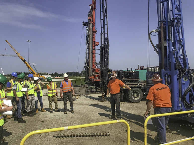 Tom Howe watches Dave Bowers, trainer at Local 150, talk about geotechnical drilling.