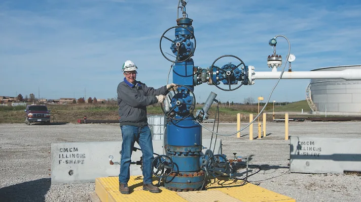 injectionwell.jpg Man stands in front of an injection well.