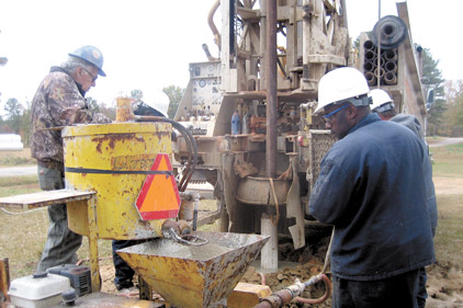 Employees of Sandersville Wells, drill at a site in Milledgeville, Ga.