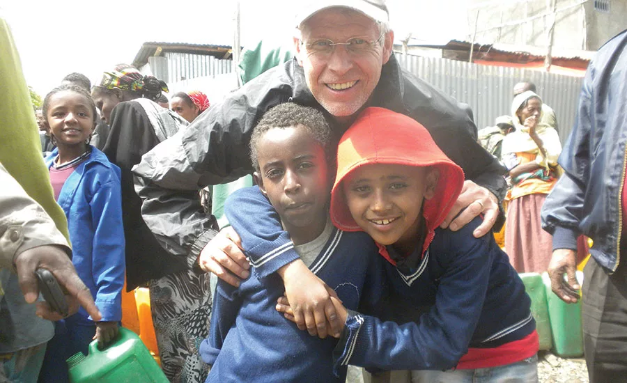 Edward Powell with local kids during a rehab project in Ethiopia