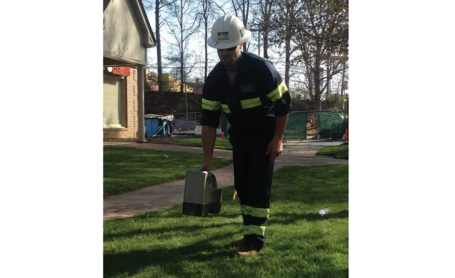 Technician uses receiver on surface