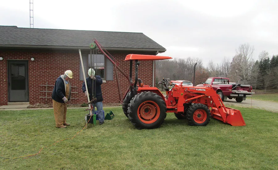Tractor rigged with lifter pulls pipe