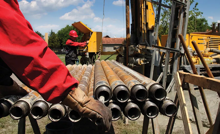 Driller and helper on jobsite