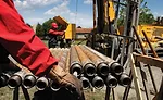 Driller and helper on jobsite