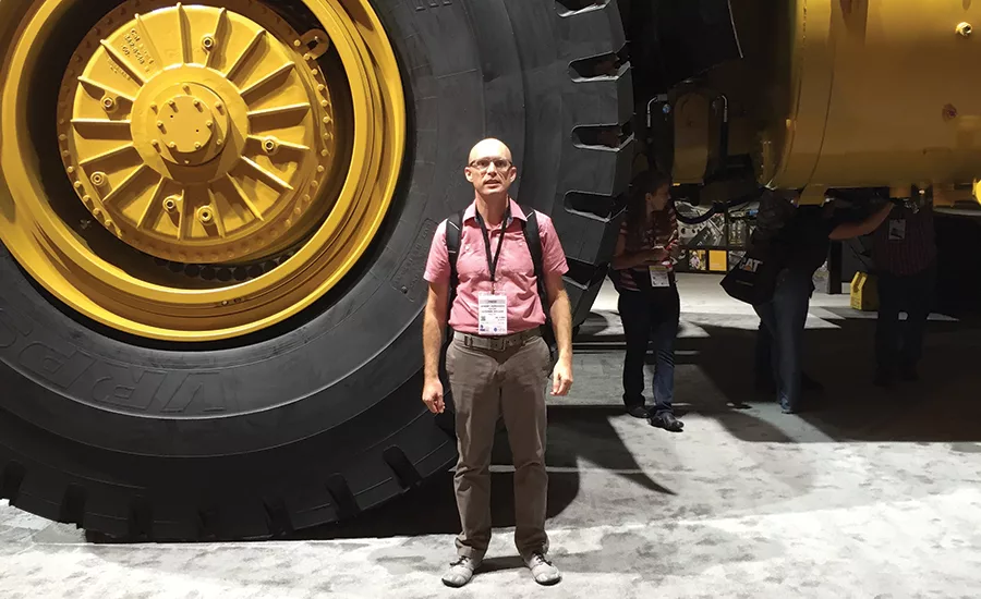 Jeremy Verdusco next to massive dump truck