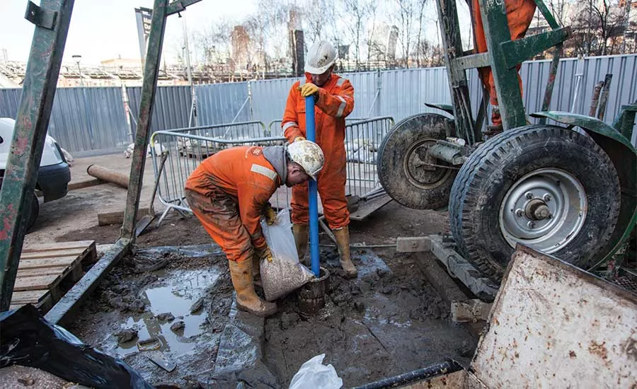 pouring gravel into a well