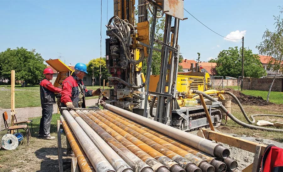 driller and driller's helper on jobsite