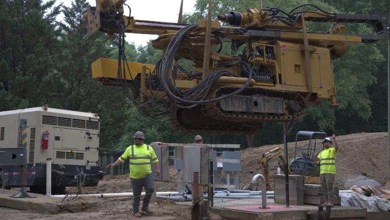 Lakeshore Engineering lowers a Beretta T46 drilling rig into the excavation