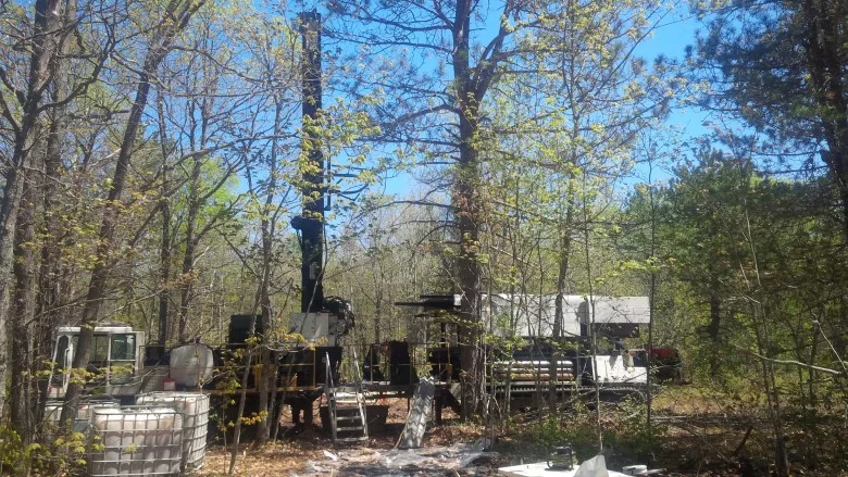 installing monitoring wells amid the scrub of the Hiawatha National Forest