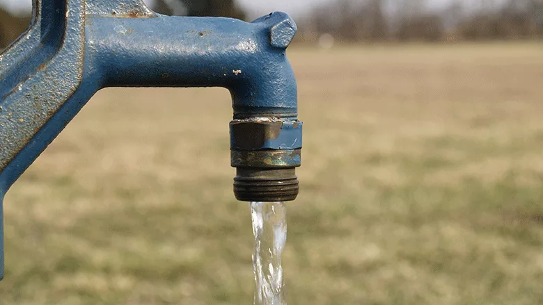 water running out of a blue water pump